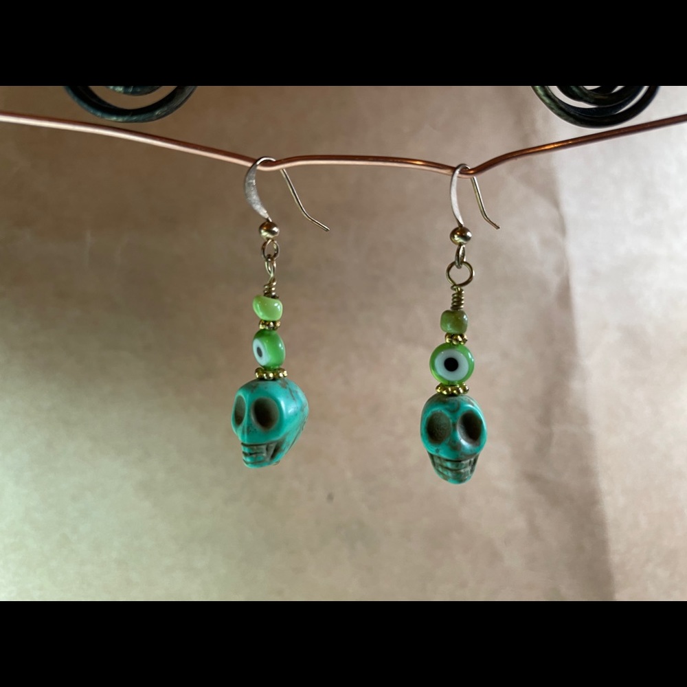 Green skull earrings.